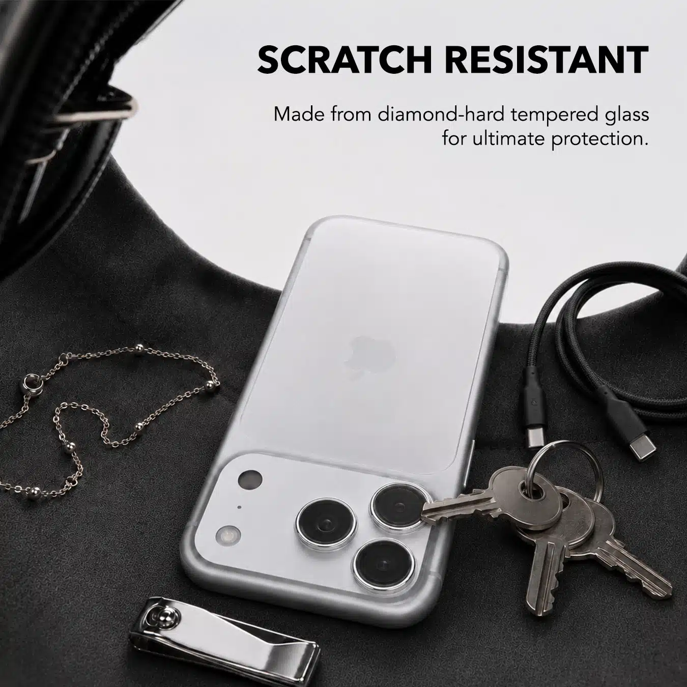 Scratch resistant Clarity lens protector on an iPhone beside keys, diamond-hard tempered glass