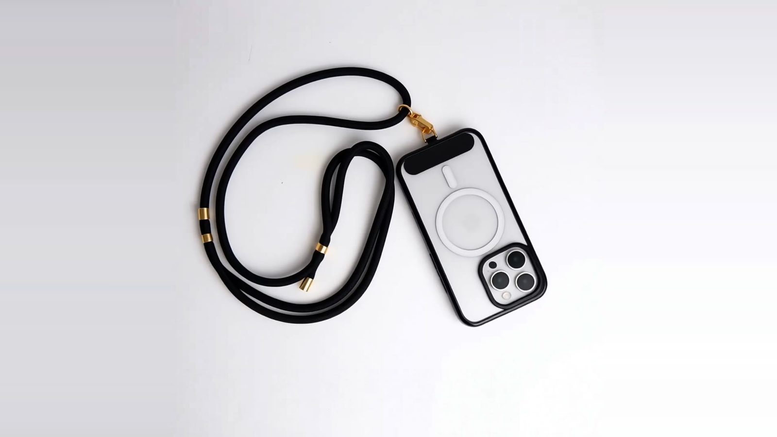 GALADO Crossbody strap: black braided rope with gold hardware, clipped to a clear case