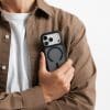 Man holding an iPhone in a black GALADO Knoxx Guard matte case