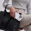 White GALADO Knoxx Guard case carried beside a black leather tote bag