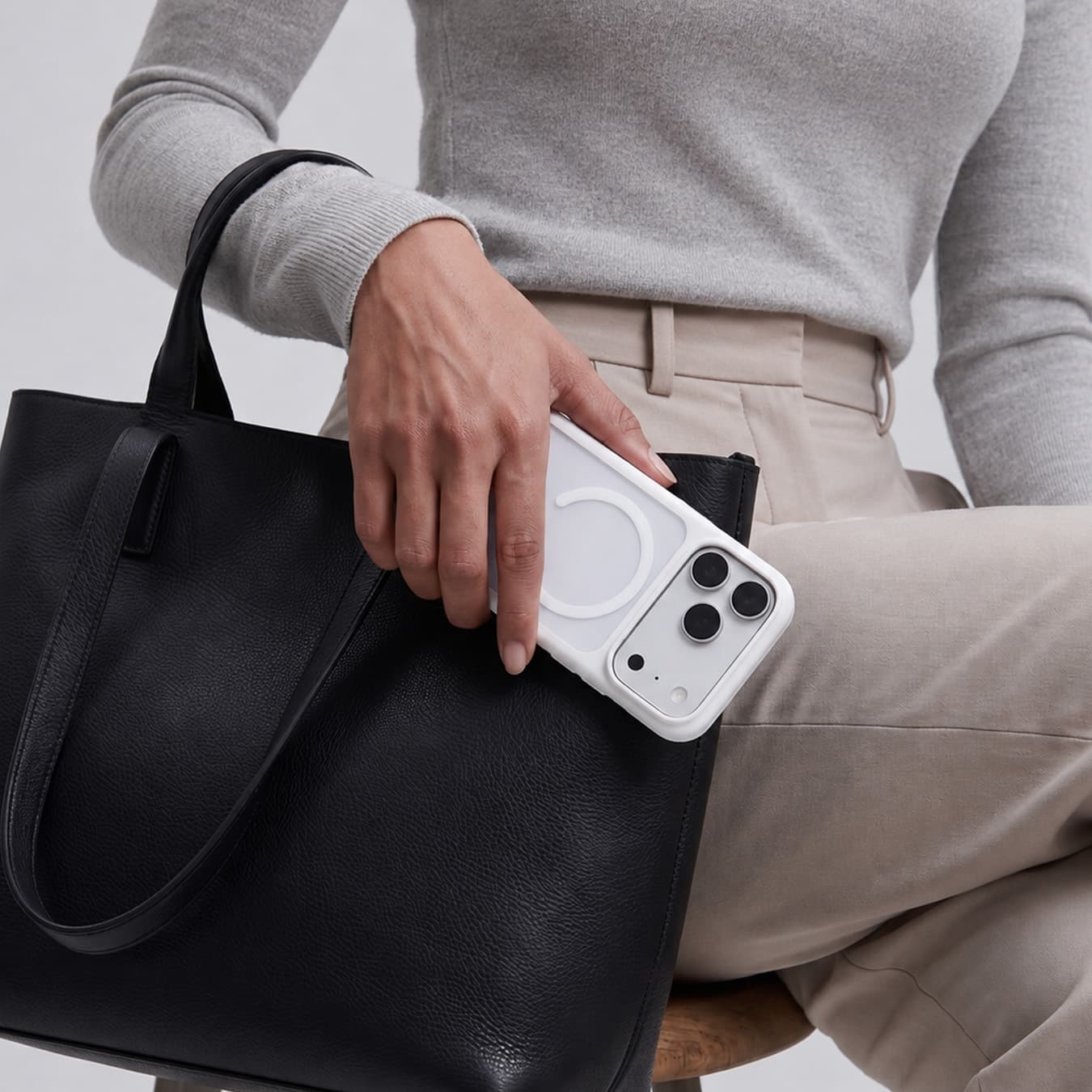 White GALADO Knoxx Guard case carried beside a black leather tote bag
