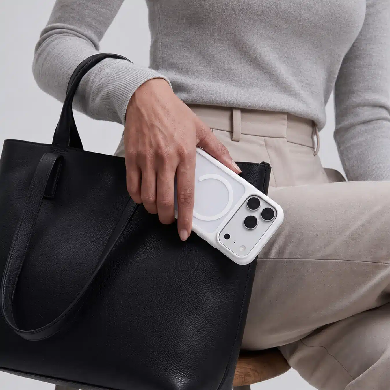 White GALADO Knoxx Guard case carried beside a black leather tote bag